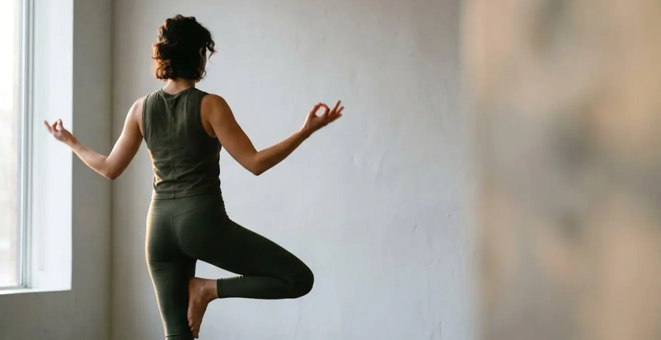 Human silhouette in contemplative pose surrounded by soft natural light representing sensory integration and balance
