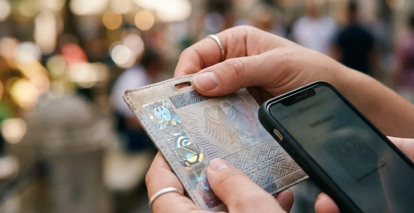 Close-up of hands examining official tour guide credentials and license badge
